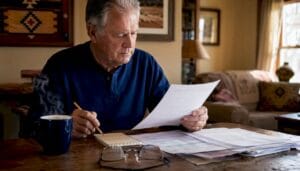 Older man reviewing reverse mortgage documents
